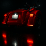 Red motorcycle with illuminated rear lights on a dark background