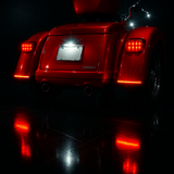 Red motorcycle with illuminated red lights on a dark background